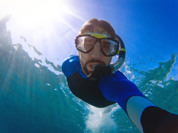 istock Young man takes underwater selfie 923663414
