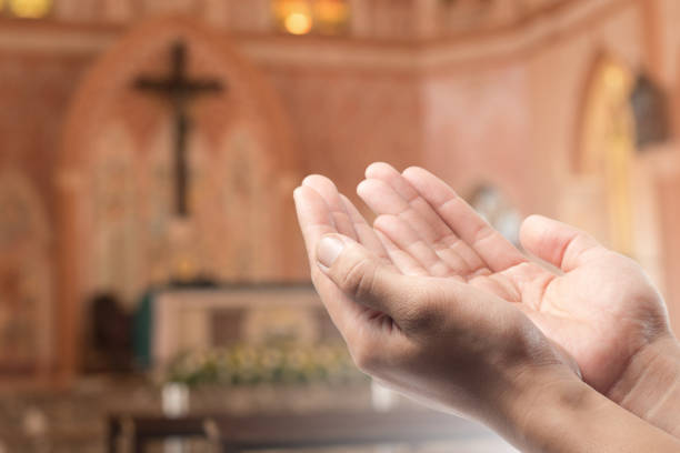 istock Human open empty hand with palms up(Praying Hand) on blurred church interior background 923666454