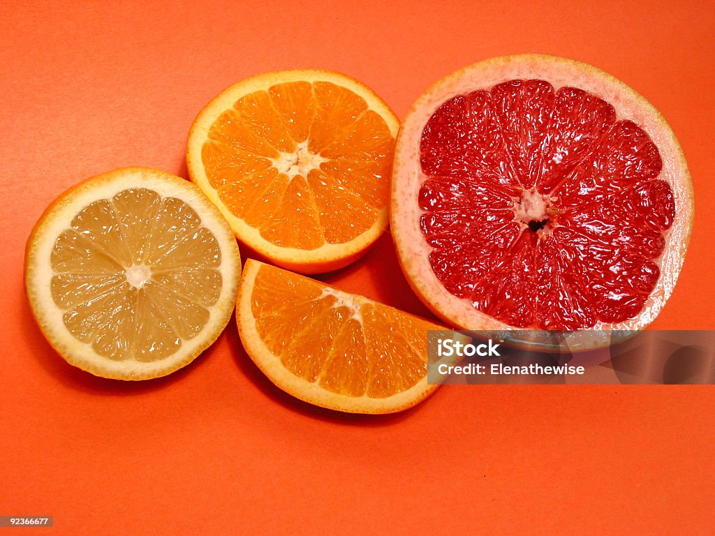 Orange, lemon, grapefruit Cut orange, lemon amd grapefruit on orange background Backgrounds Stock Photo