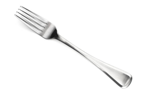 A four fingered stainless steel fork made in Sheffield Close up isolated shot of a fork. fork photos stock pictures, royalty-free photos & images