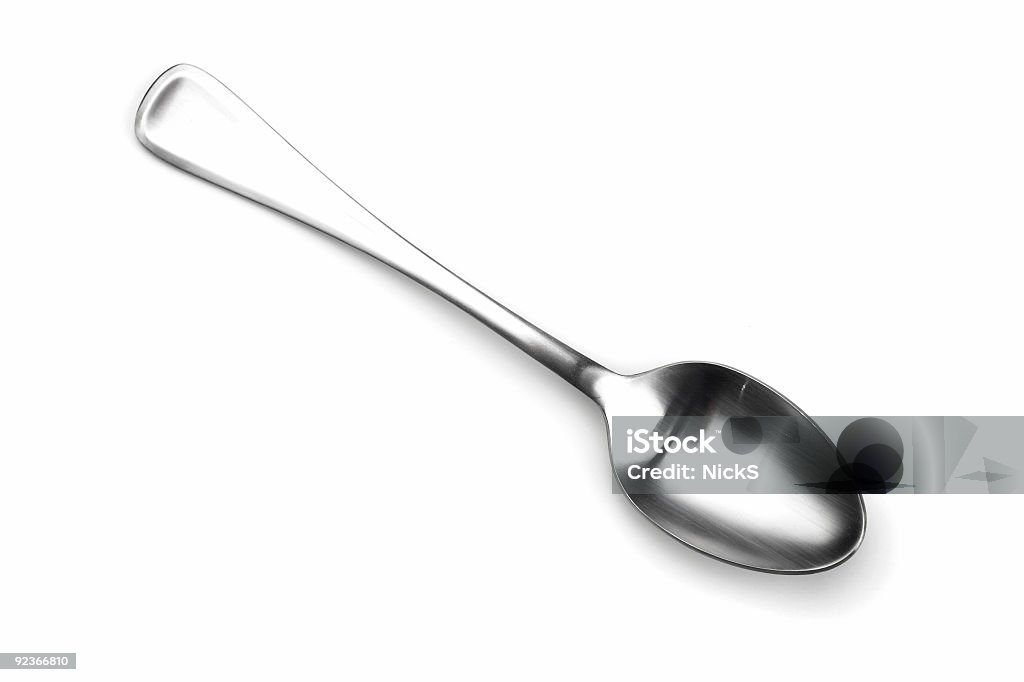 Isolated spoon shining on white Close up isolated shot of a spoon. Spoon Stock Photo