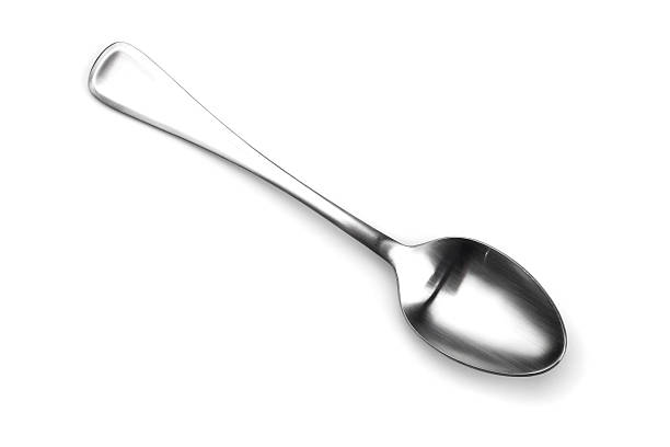 Isolated spoon shining on white Close up isolated shot of a spoon. spoon stock pictures, royalty-free photos & images
