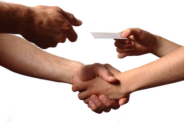 istock Two people shaking hands and handing over a business card 92366835