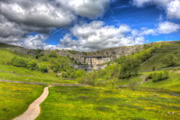 Malham Cove Yorkshire Dales National Park England UK popular tourist attraction in colourful hdr