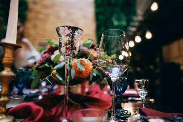 istock Wedding Banquet with red table setting decoration. Red tablecloth, white dishes, silver cutlery and red fresh flowers 923670814