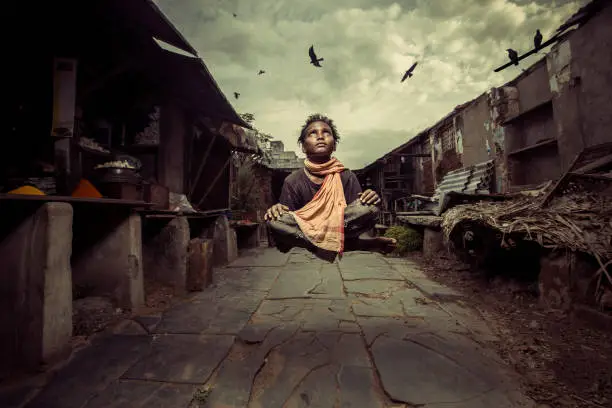 Photo of Levitation shot of poor boy at slum area poverty concept