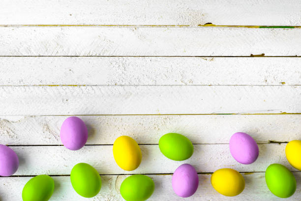 istock Wooden background with easter eggs, spring traditional eggs colored in pastel colors 923674398