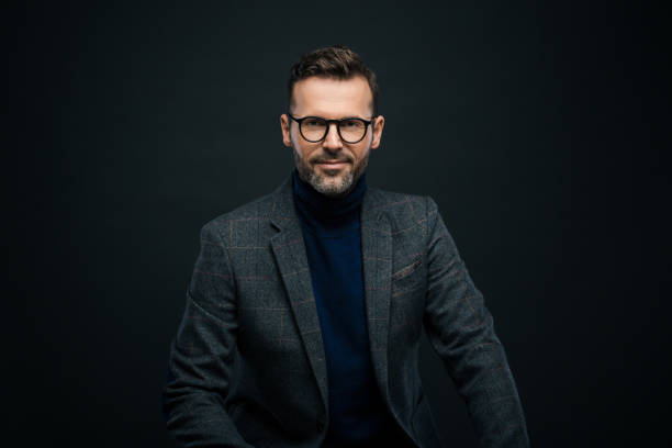istock Studio portrait of elegant man, dark background 923675410
