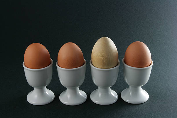 strano un uovo in legno fuori - hard cooked egg foto e immagini stock