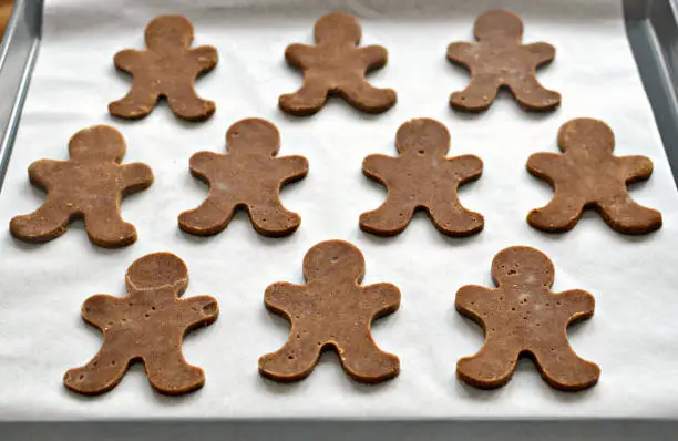 Gingerbread men on baking sheet, uncooked