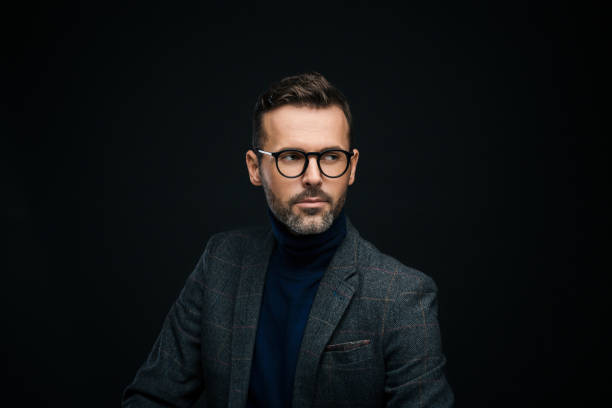 istock Studio portrait of elegant, charming man, dark background 923677918