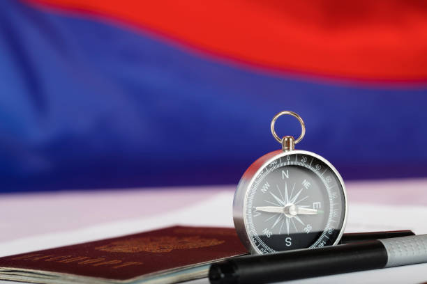 istock Magnetic compass, Russian pass and black pen on ballot paper. 923678084