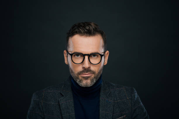 istock Studio portrait of elegant, charming man, dark background 923678724