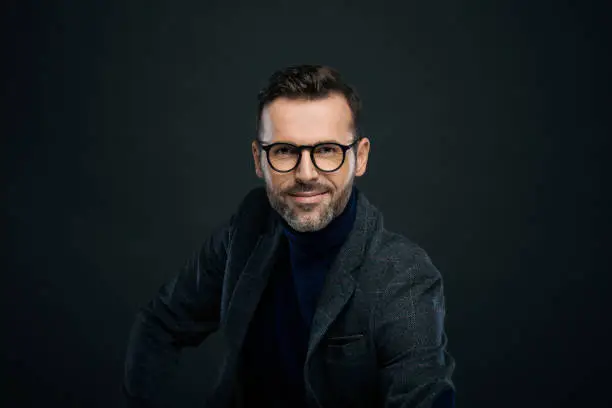 Photo of Studio portrait of elegant man, dark background