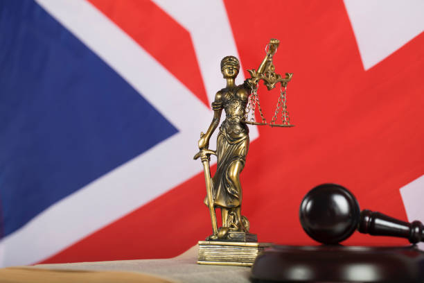 istock Statue  Themis on a flag of Great Britain. 923681576