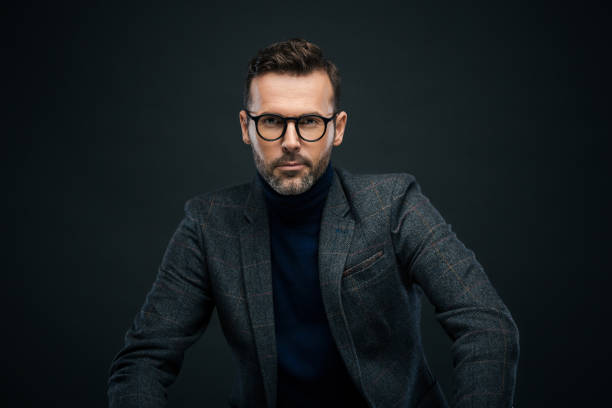 istock Studio portrait of confident man, dark background 923682172