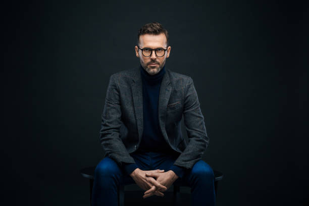 istock Studio portrait of confident businessman, dark background 923682356