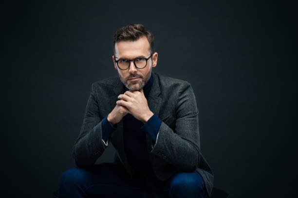 istock Studio portrait of confident man, dark background 923684784