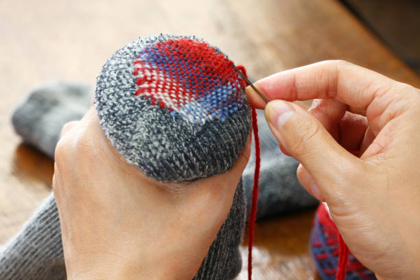 istock darning socks, repairing holes in socks 923686476