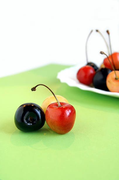 istock Three colorful sweet cherries on a green napkin 92368716
