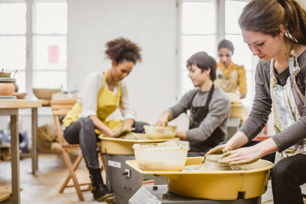 istock Small Group of People Creating Pottery on The Wheel 923691088