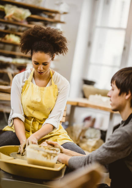 istock Man and Woman Working on Pottery Wheel 923691134