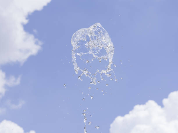 istock Fountain water splash against blurred sky with clouds, selective focus, shallow DOF. 923693652