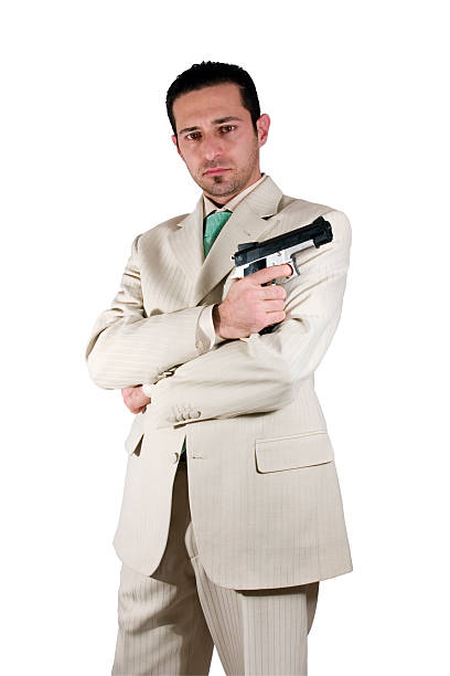 istock Mafia with arms crossed and a gunon hand 92369426