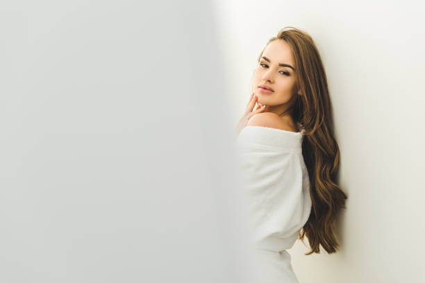 istock attractive young woman in bathrobe looking at camera 923698126