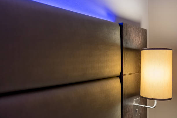 istock Ambient blue lighting seen illuminated behind a headboard in a luxury apartment. 923698502