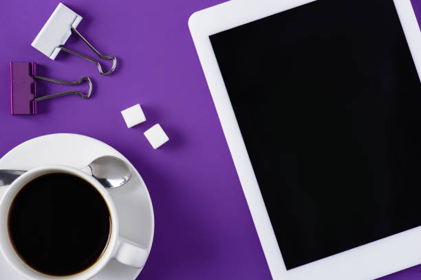 istock top view of purple workspace with coffee cup and tablet 923700070