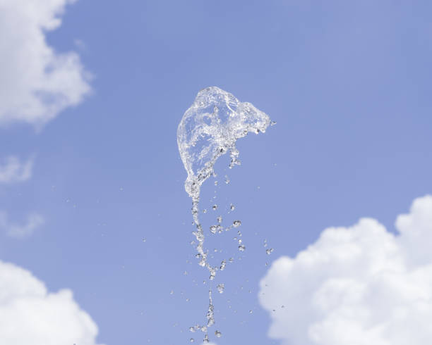 istock Fountain water splash against blurred sky with clouds, selective focus, shallow DOF. 923703446
