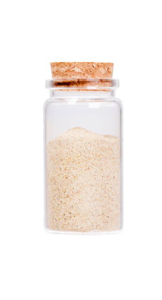 istock Cardamom in a glass bottle with cork stopper, isolated on white 923705008