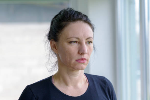istock Thoughtful woman staring out of a window 923718306