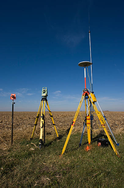 istock GPS, Total station and Prism lined up in a field 92371837