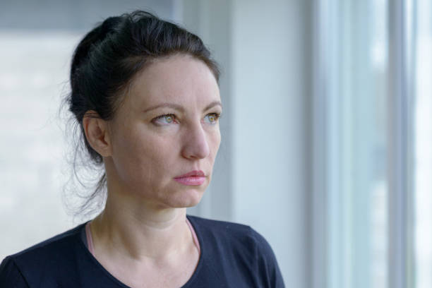 istock Thoughtful woman staring out of a window 923722182