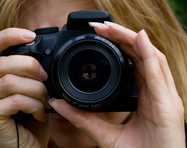 istock Woman Holding an SLR Camera 92372428