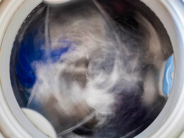 istock Top loading washing machine washes laundry. Internal view of a washing machine drum during wash. Top view. 923729004