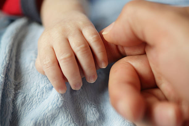 istock Newborn baby holding hands with dad 92372906