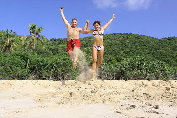 istock Young couple jumping on a tropical beach 92373034