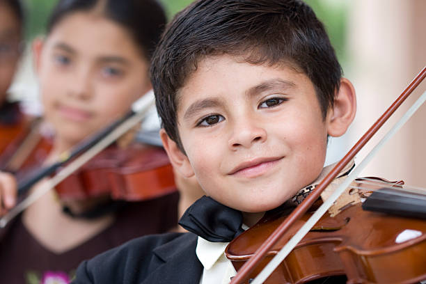 istock Children playing violins in a classical music concert 92373715