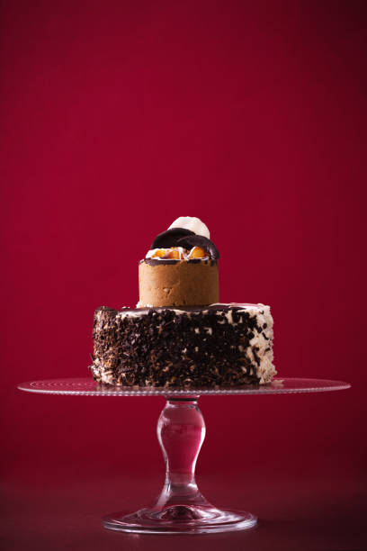 istock cake on glass plate on red background 923737638