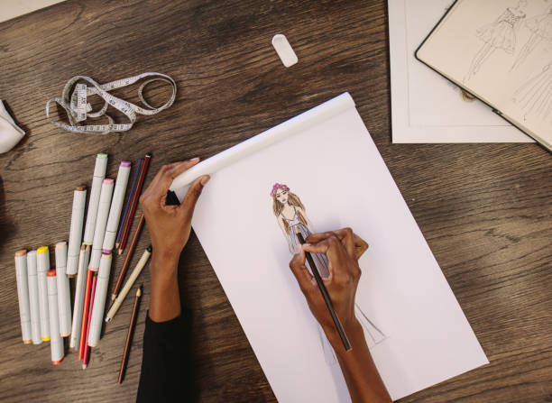 istock Fashion designer making a drawing in her studio 923738524