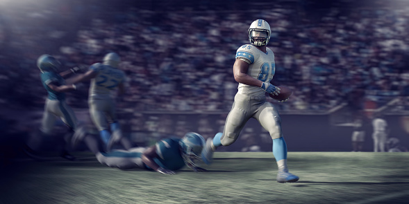 A composite image of a generic male professional American Football player running holding a football during a American Football game. There is motion blur to the main player and background players as the camera pans to follow the action. All players are CG models dressed in generic kit.