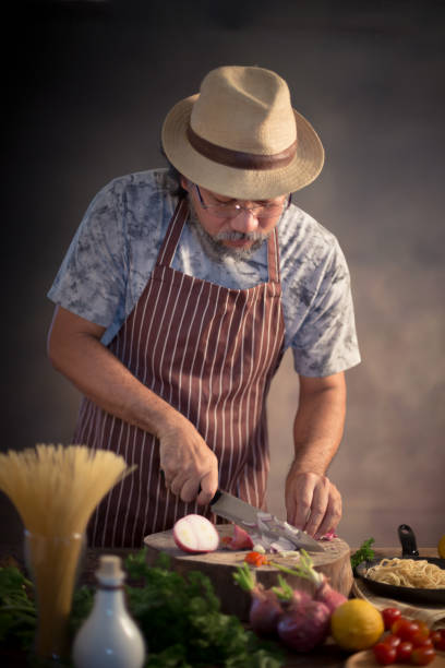 istock Man cook chef hipster with handsome bearded face in a hat 923748390