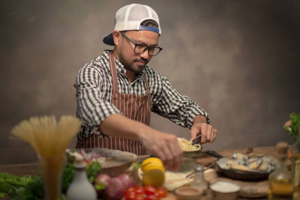 istock Man cook chef hipster with handsome bearded face in a hat 923748404