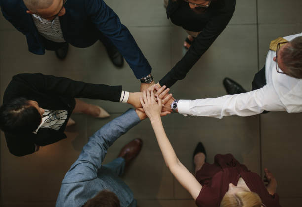 istock Business team putting hands together at the office 923748468