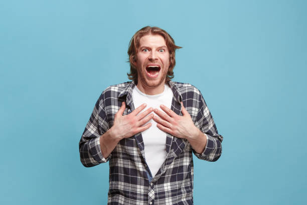 istock Beautiful man looking suprised isolated on blue 923749036