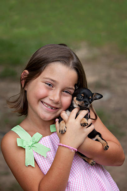 istock Seven year old child with missing teeth and puppy 92374958