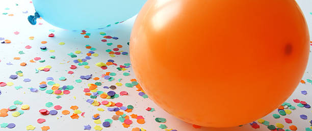 istock Blue and orange balloons with confetti 92375072